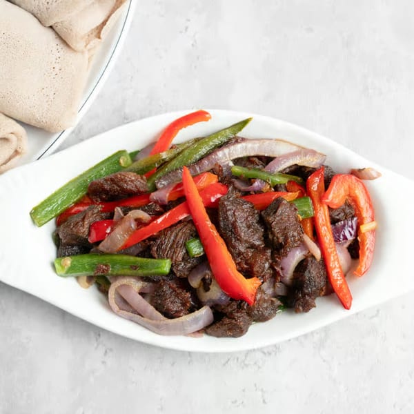 Manna Bistro's Ethiopian tibs, a dish of sautéed beef, red peppers, green beans, and onions, with injera.