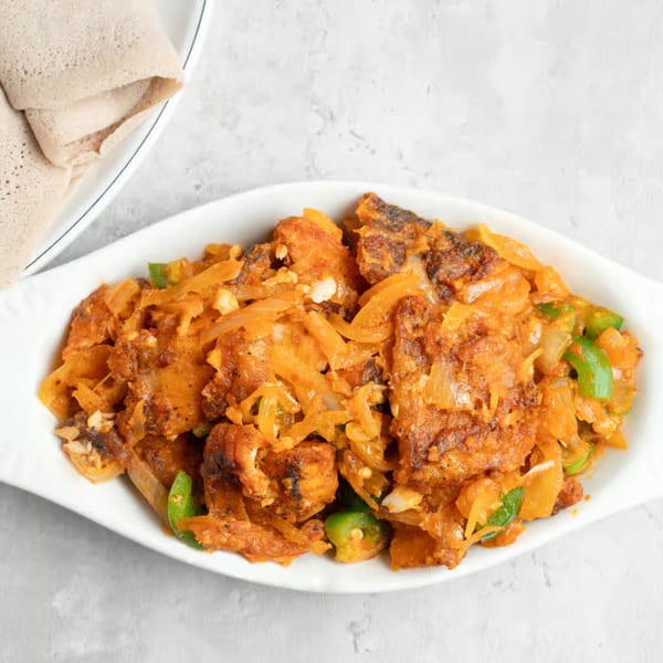 Manna Bistro's Ethiopian dish with spiced meat, onions, and green peppers, served with injera bread.