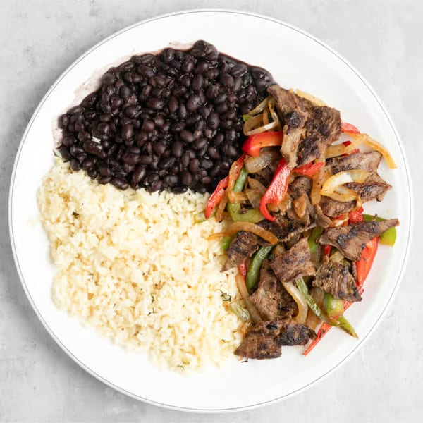Manna Bistro's Ethiopian dish with grilled meat, peppers, onions, rice, and black beans.