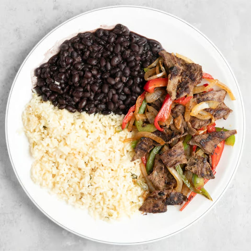 Manna Bistro's Ethiopian dish with grilled meat, peppers, onions, rice, and black beans.