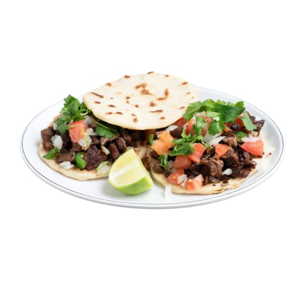 Two Ethiopian tacos with meat, tomatoes, onions, cilantro, and a lime wedge on a white plate.